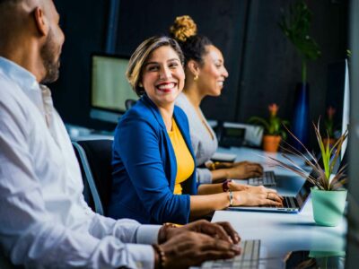 Two women and a man working at a desk