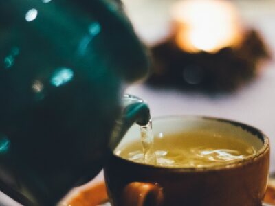 Pouring tea from a pot into a cup